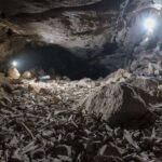 Thousands of human and animal bones hoarded by hyenas in lava tube system, Saudi Arabia
